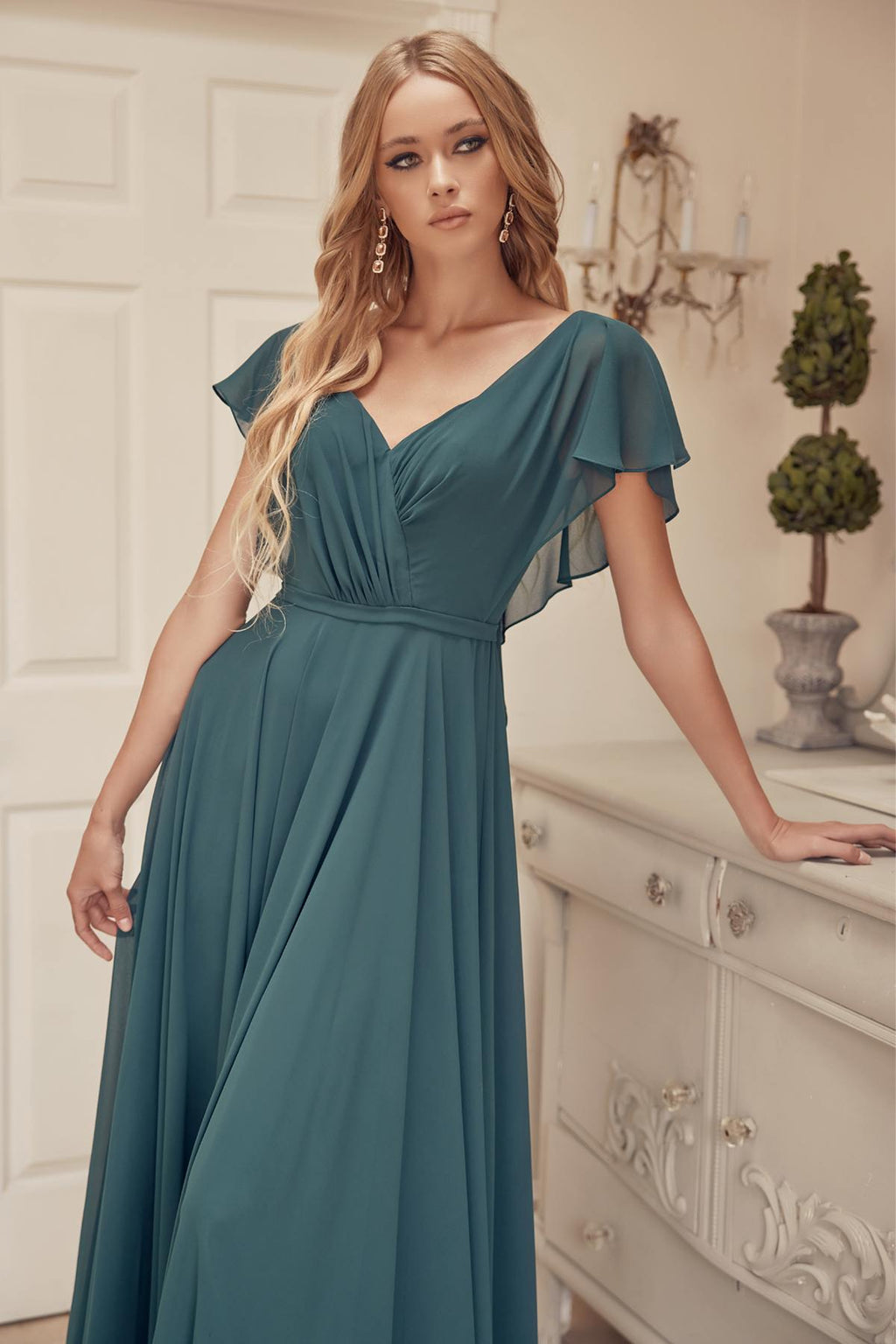 Teal V-neck formal dress with flutter sleeves, cinched waist, and full maxi skirt