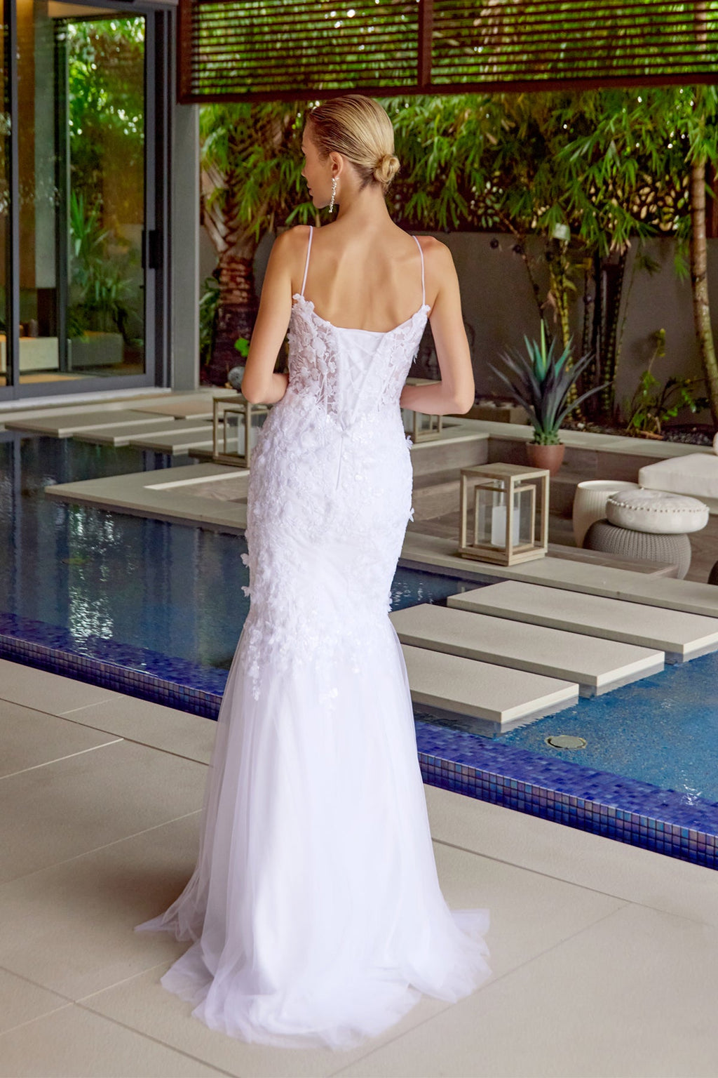 White back view lace trumpet gown with spaghetti straps and long flared tulle hem