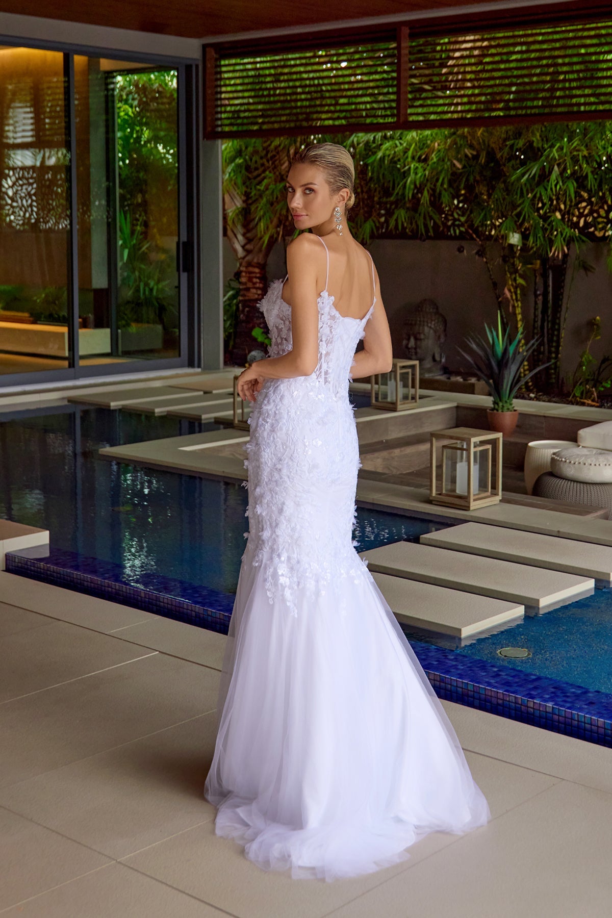 Embellished trumpet gown in off-white with lace straps and textured corset bodice, side view