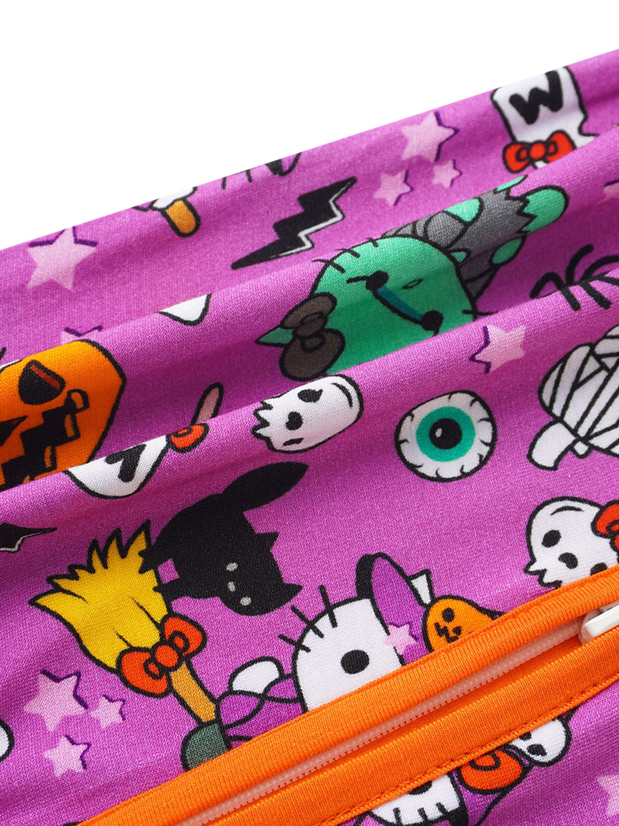 Baby romper fabric detail with purple cartoon print and orange zipper seam