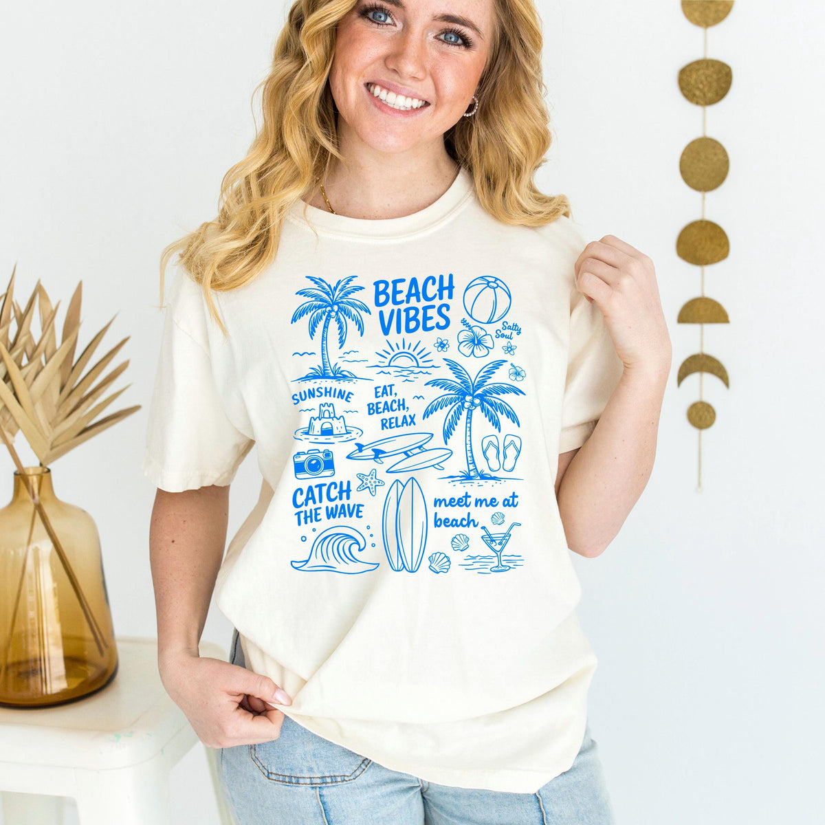 Ivory women’s T-shirt with blue “Beach Vibes” front graphic on the chest
