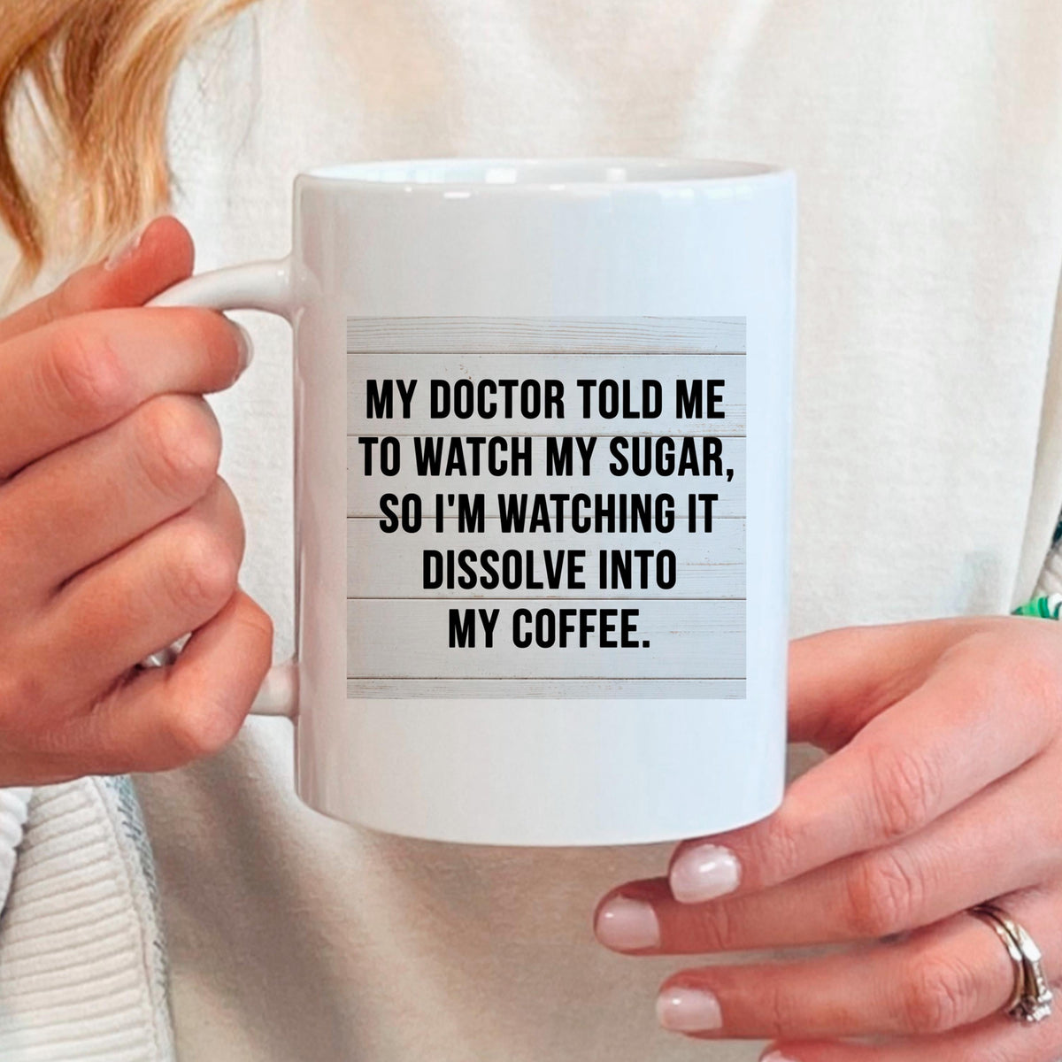 White coffee mug held in hands with printed quote “My doctor told me...”
