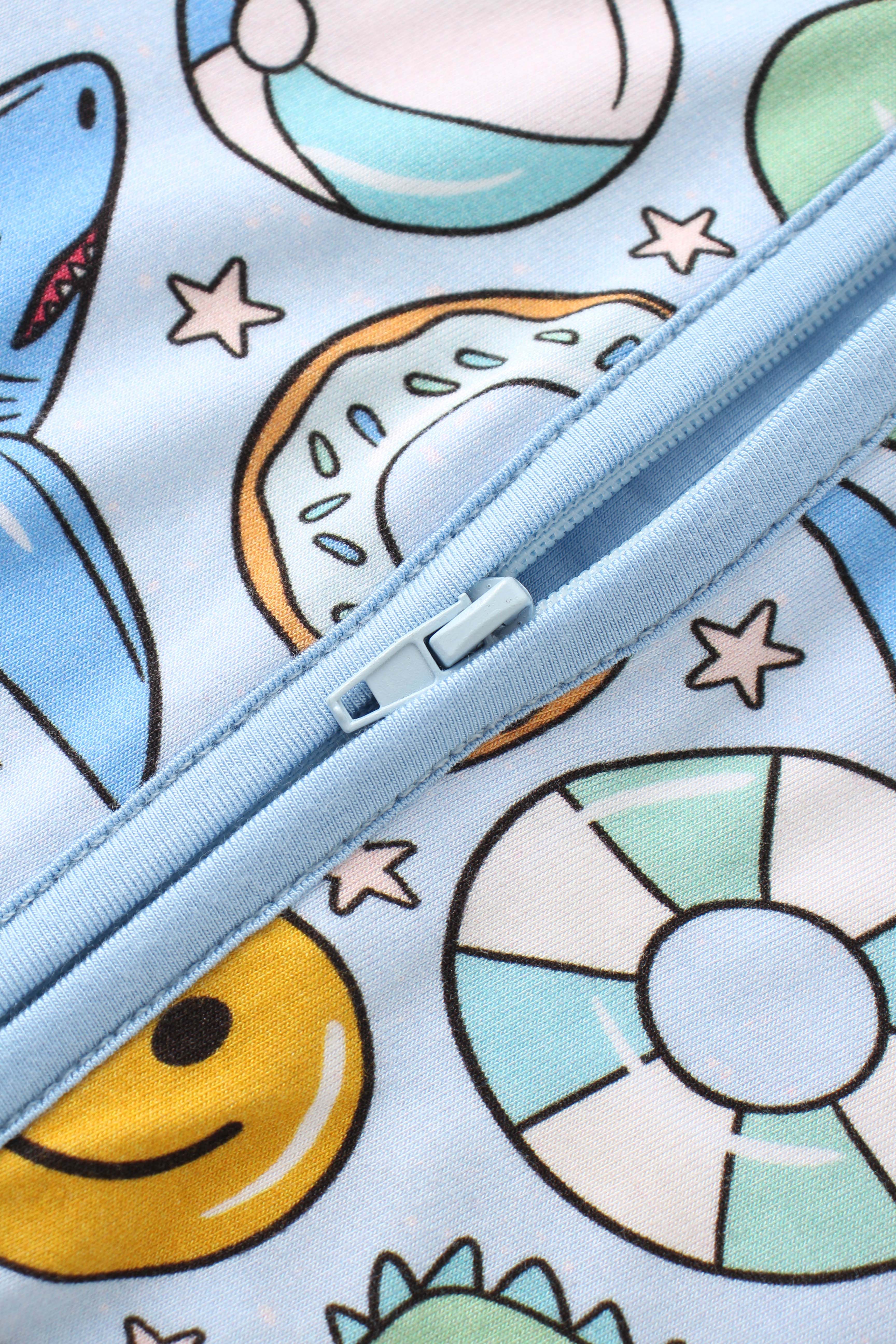 Baby romper zipper close-up on light blue placket with colorful space print