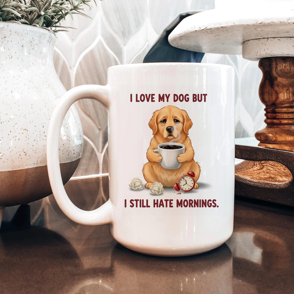 White ceramic dog lover mug with dog holding coffee and red alarm clock; text: I still hate mornings.