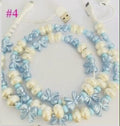 Beaded 4-in-1 charging cable with light blue bow beads and white connectors