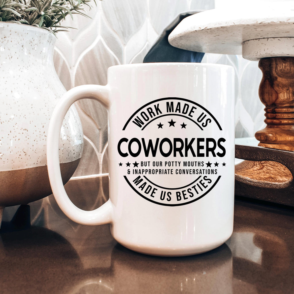 White ceramic mug with black circular coworker saying print and curved handle