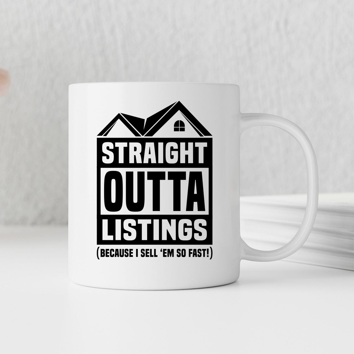White ceramic coffee mug with black “STRAIGHT OUTTA LISTINGS” lettering