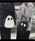 Ghost crossbody handbag in white with black eye-dot face and adjustable shoulder strap