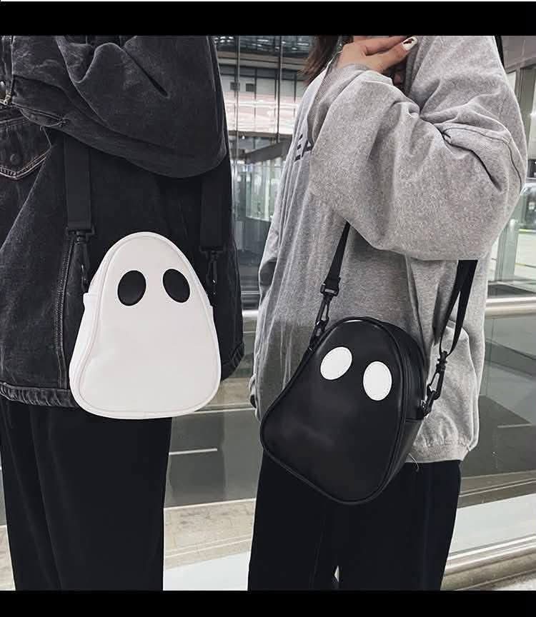 Ghost crossbody handbag in white with black eye-dot face and adjustable shoulder strap