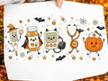 Halloween graphic tee with smiling cat, robot, pumpkin, bats, spiderweb, and medical icons