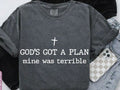 Dark gray T-shirt with white cross and 'GOD'S GOT A PLAN' text