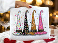 White graphic tee with colorful witch hat illustration and stars, hearts, and polka dots