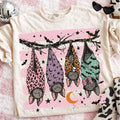 Cream graphic tee with sleeping bats and stars on front