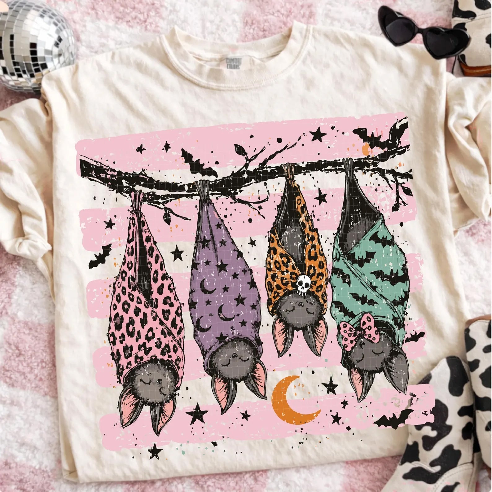 Cream graphic tee with sleeping bats and stars on front