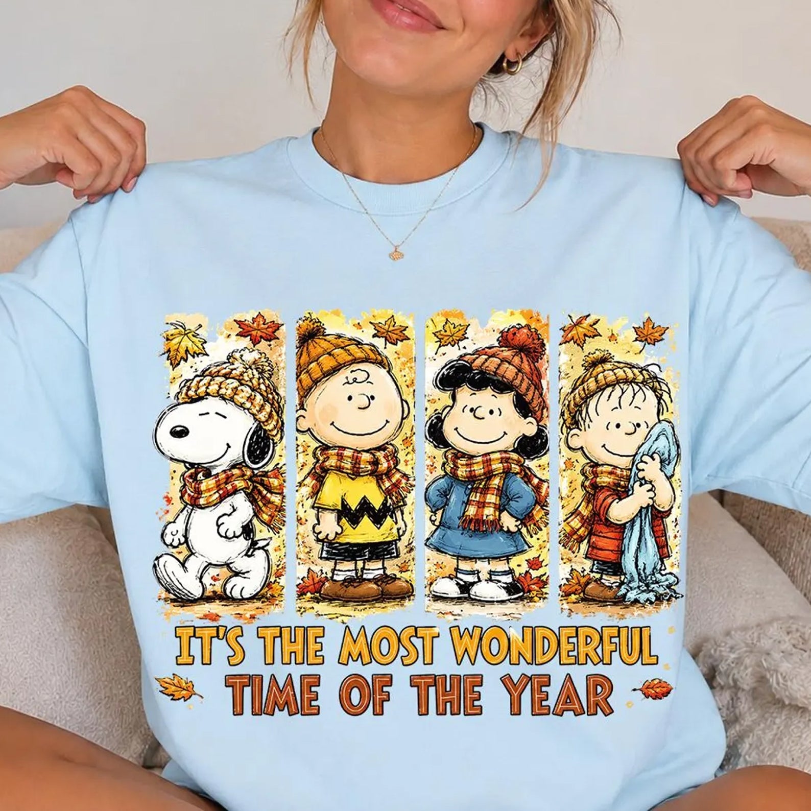 Light blue holiday graphic tee with cartoon characters and 'It's the most wonderful time of the year'
