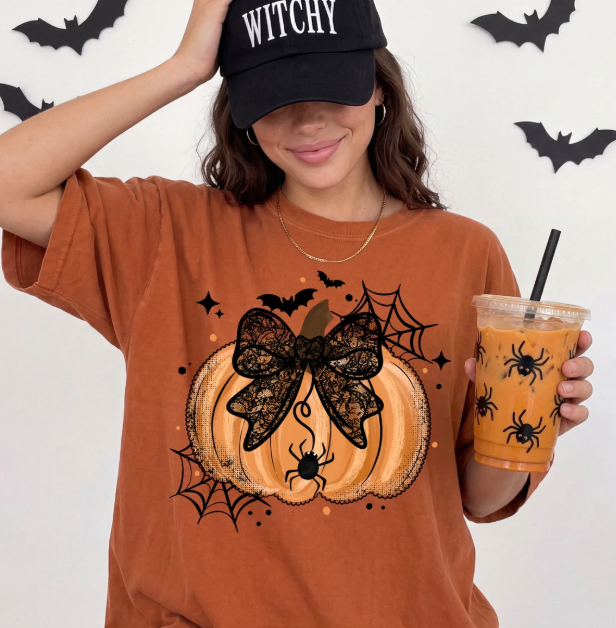 Rust orange graphic tee with black bow and pumpkin spiderweb print, short sleeves