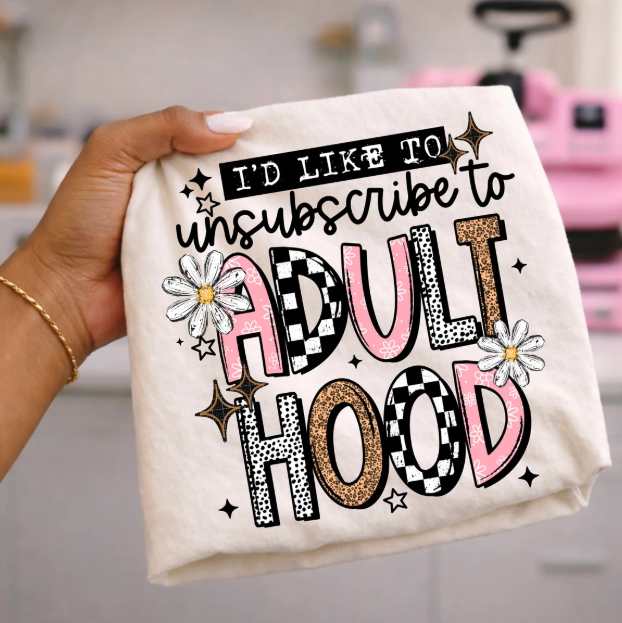 Graphic tee with white text and pink, black, and gold “adult hood” design