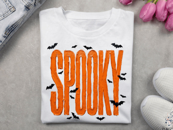 White graphic tee with orange SPOOKY lettering and black splatter accents