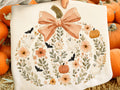 Light cream graphic tee with painted pumpkin and floral wreath
