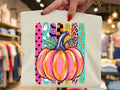 Light graphic tee with multicolor striped pumpkin illustration front