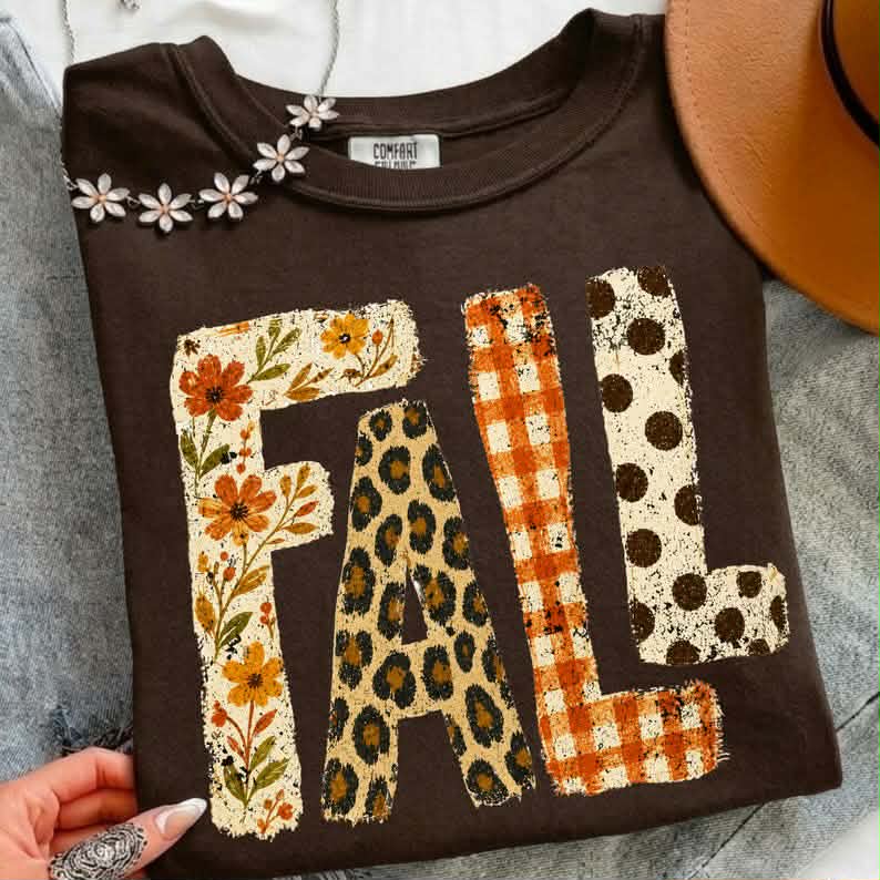 Dark brown fall graphic tee with 'FALL' patchwork letters print across chest