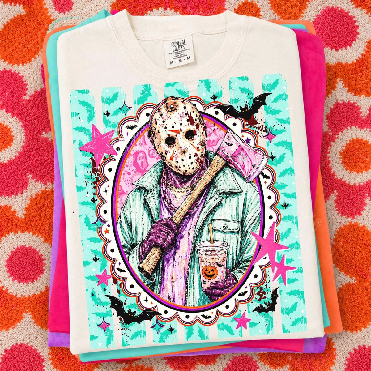 White graphic Jason-style tee with front face mask illustration and teal pink splash design