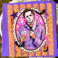 Purple graphic tee with illustrated skeleton clown holding a drink and microphone