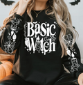 Black long-sleeve crewneck tee with white Basic Witch candle graphic