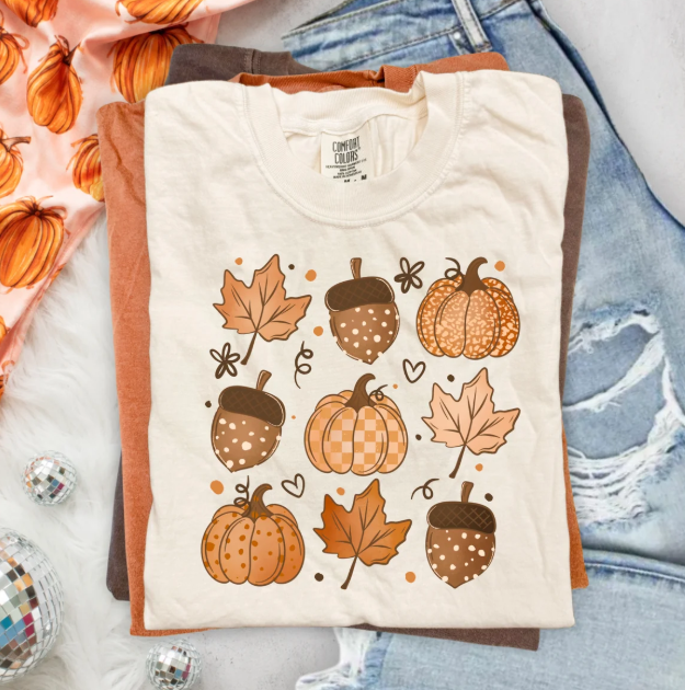 Cream graphic tee with fall leaves, acorns, pumpkins illustration on front