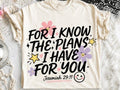 Cream graphic tee with “For I know the plans I have for you” front text and stars