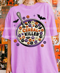Purple graphic tee with large circular cereal-and-bats print reading "Cereal Killer"