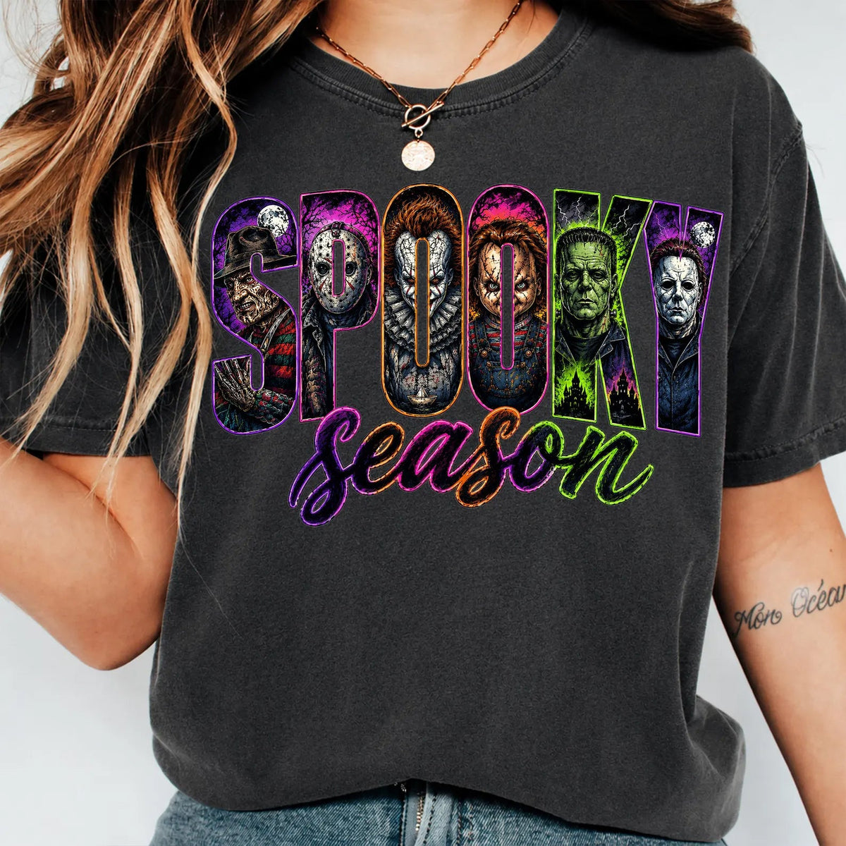 Black crewneck graphic tee with “Spooky Season” lettering and monster face collage