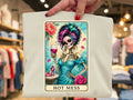 White graphic tee with colorful skeleton woman illustration and rose accents, 'HOT MESS' text