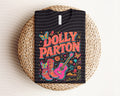 Black graphic tee with neon 'Dolly Parton' lettering and colorful cat artwork