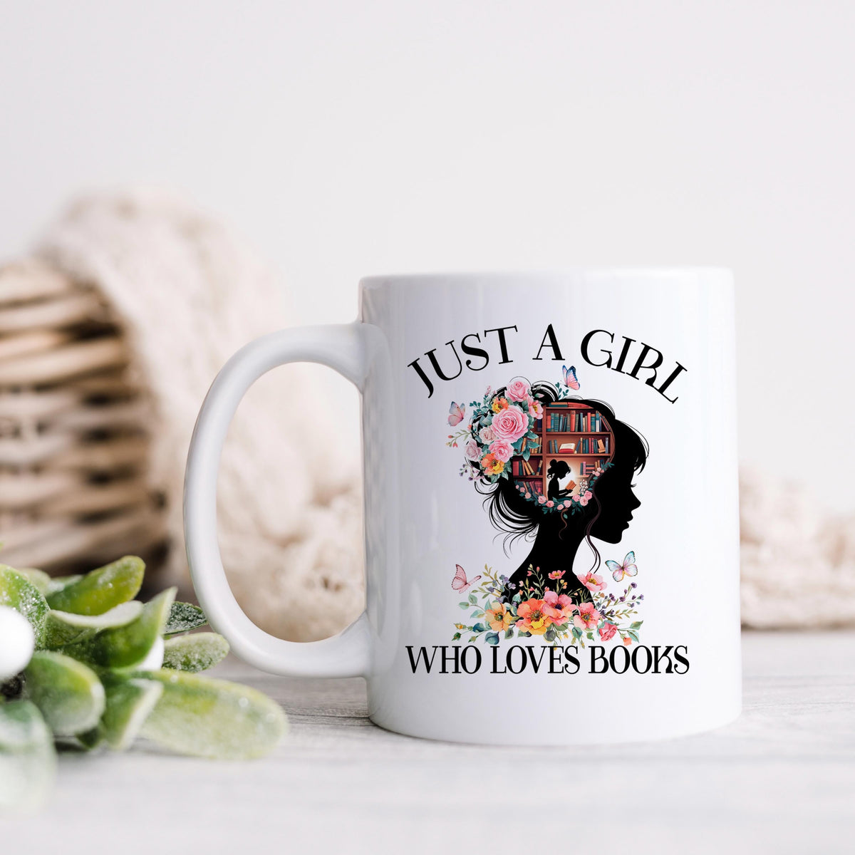 Ceramic coffee mug with black handle and floral book design on white background.