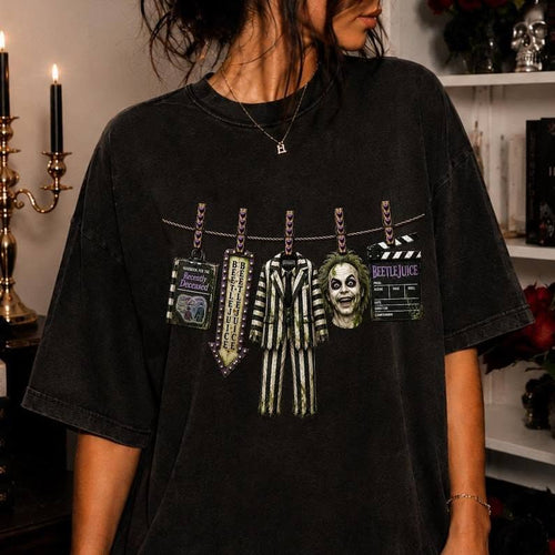 Black Beetlejuice graphic tee with clothesline hanging tags and face print