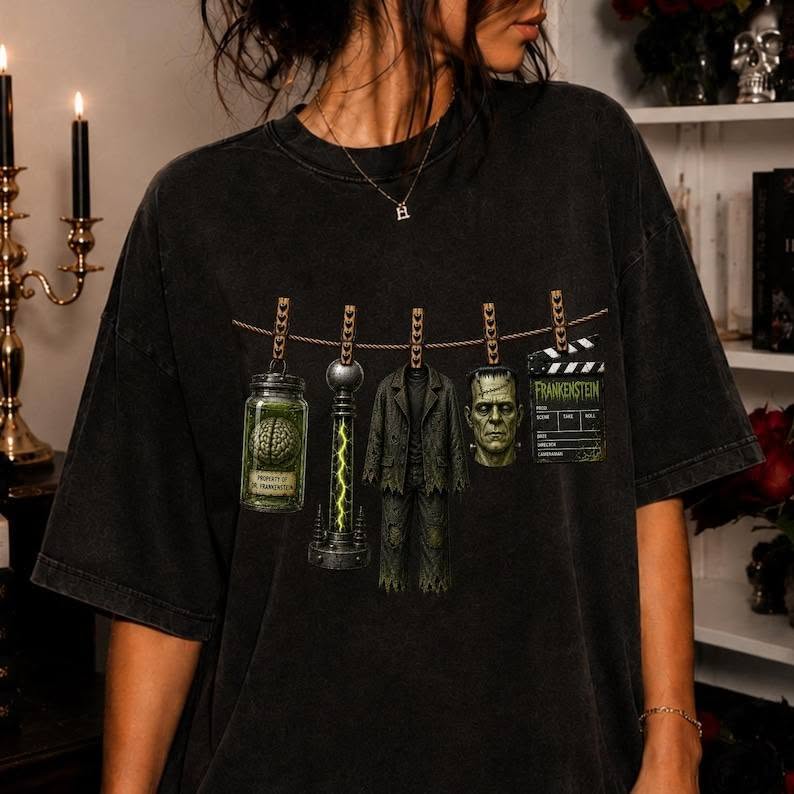 Dark crewneck graphic tee with Frankenstein head and hanging clothesline props
