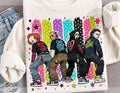 White graphic crewneck tee with twerking characters, stars, and multicolor splatter print