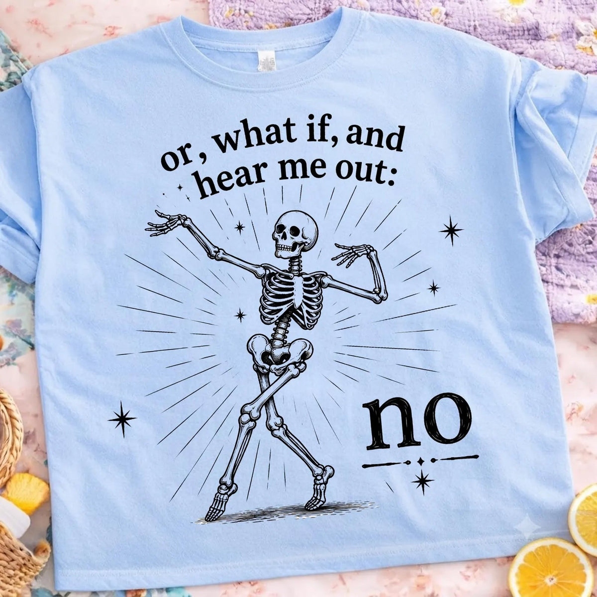 Light blue graphic tee with skeleton and 'hear me out' + 'no' text