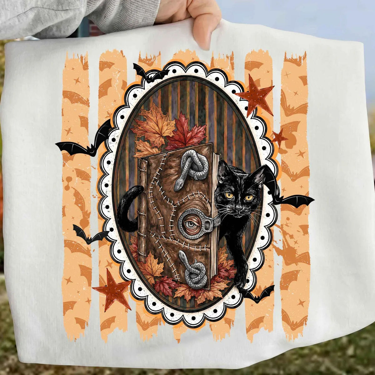 White short-sleeve graphic tee with framed black cat illustration.