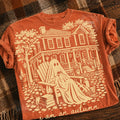 Rust orange graphic tee with large autumn scene print and “I am an Autumn” text