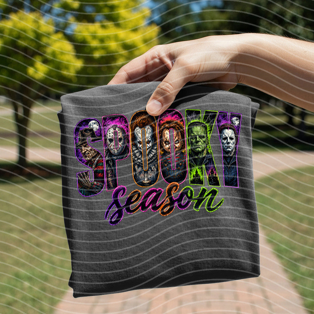 Dark gray graphic tee with “Spooky Season” horror faces and purple lettering