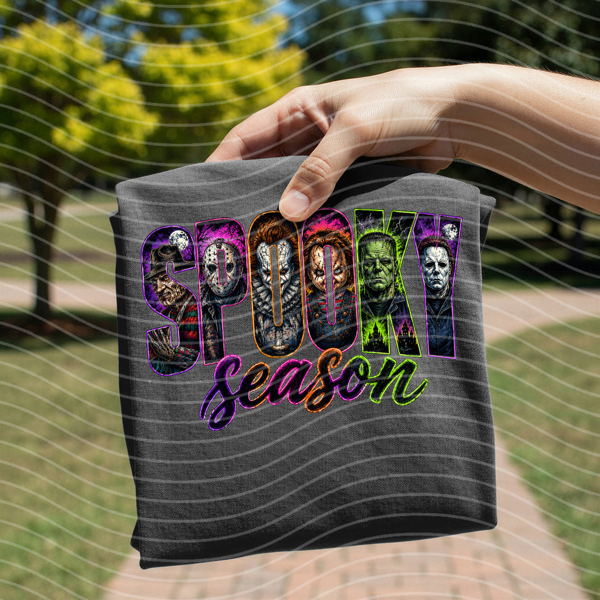 Dark gray graphic tee with “Spooky Season” horror faces and purple lettering