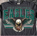 Dark gray crewneck graphic tee with large eagle emblem and 'PHILADELPHIA EAGLES' text