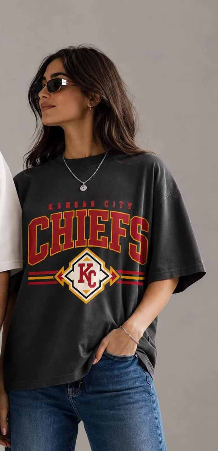 Dark charcoal Chiefs shield graphic tee with red and yellow logo on front