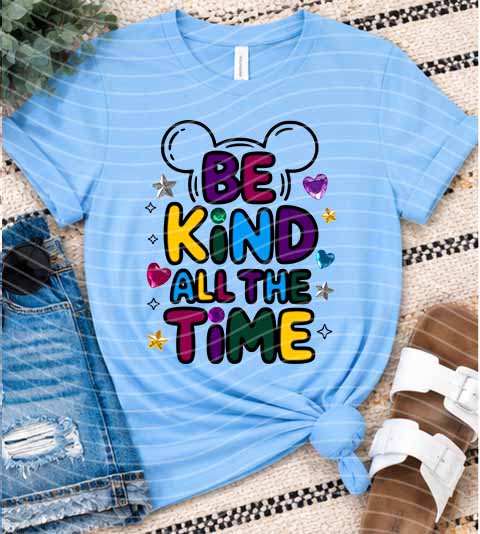 Light blue graphic T-shirt with 'BE KIND ALL THE TIME' colorful letters and hearts