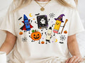 White graphic tee with Halloween school characters: wizard, chalkboard, pumpkins