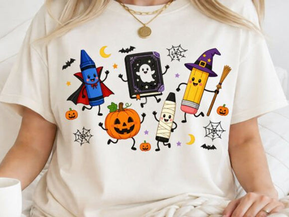 White graphic tee with Halloween school characters: wizard, chalkboard, pumpkins