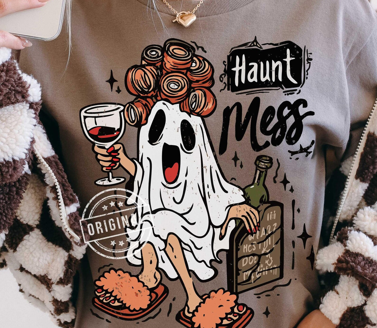 Light crewneck tee with cartoon ghost and 'Haunt Mess' graphic in orange and black