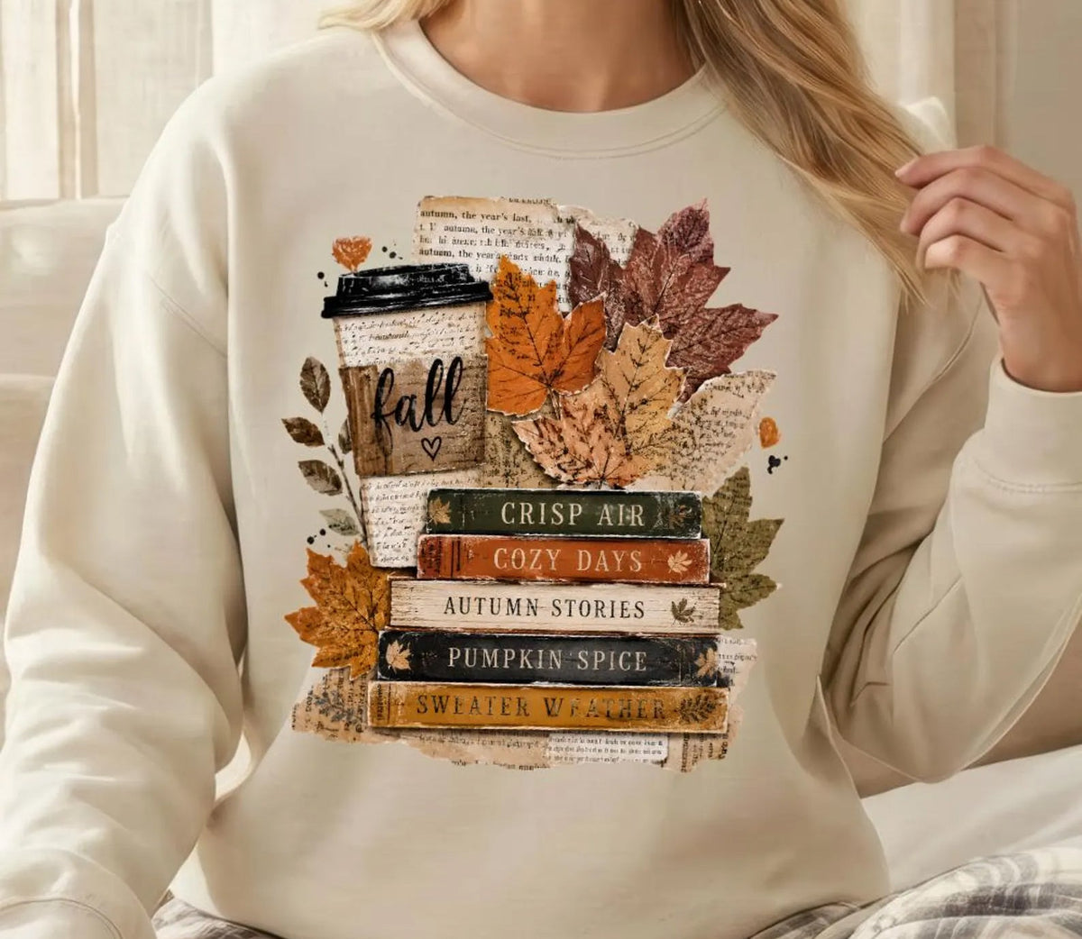 White long-sleeve graphic tee with layered fall leaves and vintage reading quote print